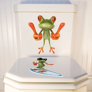 Detailed view of funny cartoon frogs waterproof stickers applied on a white toilet