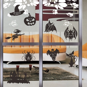 Halloween vinyl wall decals featuring witch and pumpkin silhouettes on a glass door