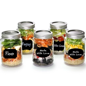Set of glass mason jars with black chalkboard labels for kitchen food storage organization