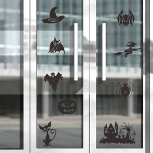 Detailed view of matte black Halloween vinyl stickers featuring ghosts and bats on glass