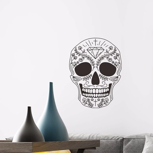 Bohemian black skull wall sticker with floral patterns on a white wall above a sofa