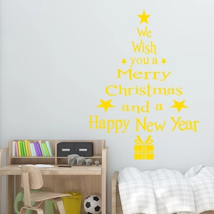 Close-up of yellow PVC Christmas tree wall decal with holiday greetings for living room