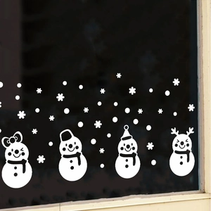 Detail view of cartoon snowman window stickers with snowflakes for Christmas decor