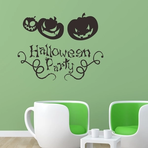 Detail of black Halloween pumpkin wall decals and party lettering on a green wall