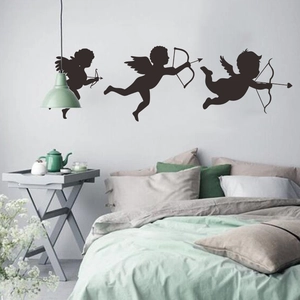 Three black silhouette Cupid wall stickers for Valentine decoration in a modern bedroom