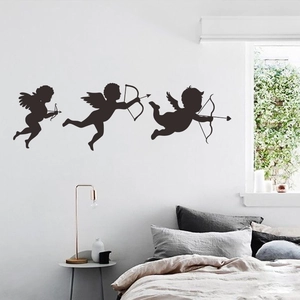 Three-piece black Cupid angel silhouette wall decals applied to a bedroom wall background