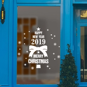 White Christmas tree window sticker with stars and bows on a glass background