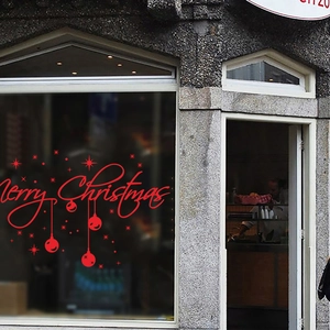 Detail showing red Merry Christmas window decals with festive star and ball ornaments