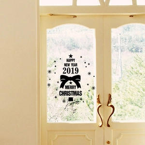 Detail of Christmas tree wall sticker with Merry Christmas text on a glass window