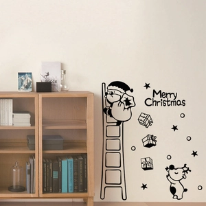 Black PVC Christmas wall decals featuring Santa Claus and reindeer on a beige interior wall