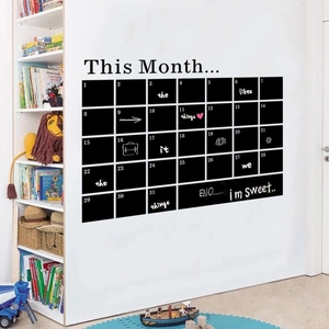 Detail of black PVC monthly calendar chalkboard sticker applied to a white office wall