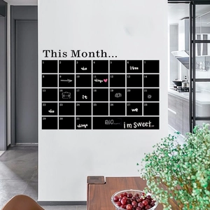 Minimalist DIY blackboard monthly calendar wall sticker in a clean modern kitchen setting