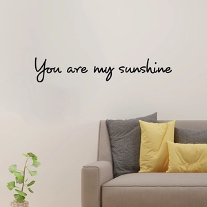 Black vinyl You are my sunshine wall decal above a beige sofa for home decoration