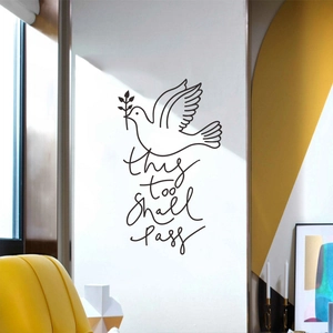 Modern wall sticker featuring a peace dove and 'this too shall pass' text in a living room