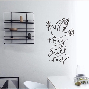 Modern peace dove wall sticker with 'this too shall pass' quote on a white wall
