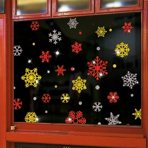 Glittery Christmas snowflake window stickers in red, gold, and silver for holiday decor