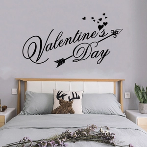 Valentine's Day LOVE wall sticker with artistic font and hearts above modern bedroom bed
