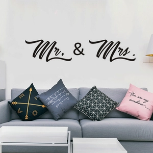 Modern black Mr. & Mrs. wall sticker above a gray sofa for living room decor