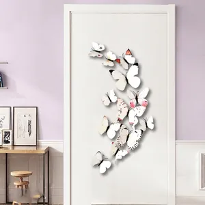 Set of 12 3D white butterfly wall stickers with pink accents on home interior wall