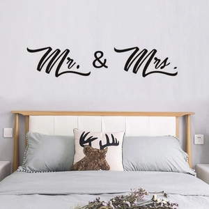 Detail of Mr. & Mrs. black vinyl wall sticker applied on a bedroom wall surface