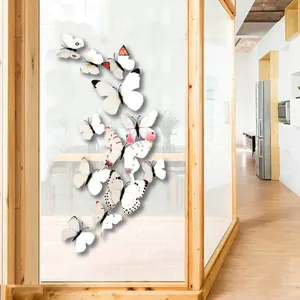 Detailed view of 3D white butterfly wall stickers with pink patterns on glass surface