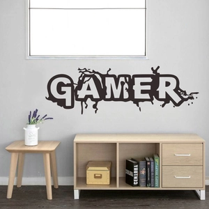 Detail view of Gamer wall sticker with ink splatter design on a minimalist grey bedroom wall