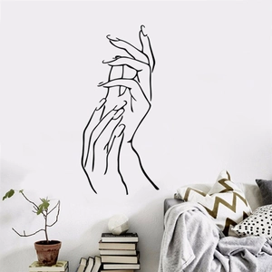 Minimalist hand line art wall sticker above a gray sofa in a modern living room decor