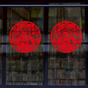 Close-up of traditional red Chinese New Year window stickers with Fu and Chun characters