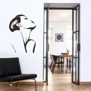 Modern minimalist black wall decal showing elegant female side profile outline in a living room