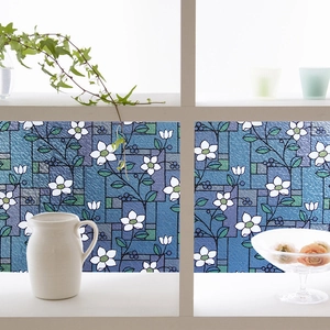 Detailed blue mosaic window film featuring delicate white flowers and green leaves pattern