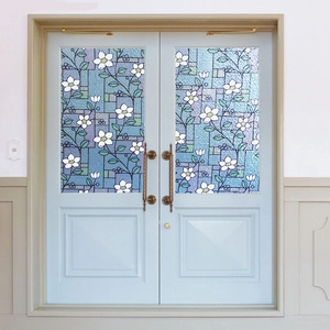 Close-up of static cling window film with white flowers and frosted glass texture