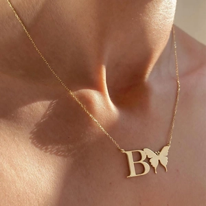 Elegant gold butterfly initial B pendant necklace on a delicate stainless steel chain