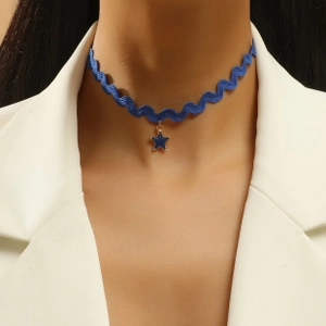 Detail showing blue lace choker with star pendant worn on model for a gothic punk style