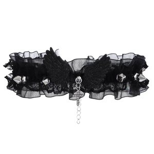 Detail of gothic black lace choker featuring embroidered wings and silver cross pendant