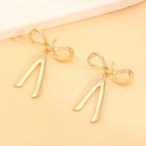 Elegant gold bow-knot stud earrings with flowing ribbon design in polished metal