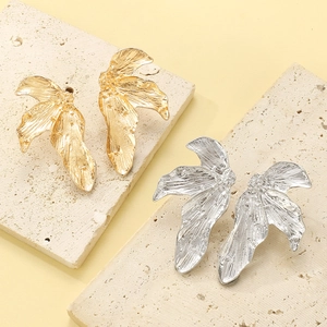 Minimalist vintage leaf design earrings in gold and silver with hammered metal texture