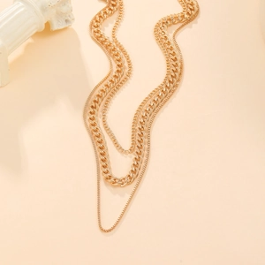 Three-layer gold-plated chunky chain necklace set on minimalist stone prop background