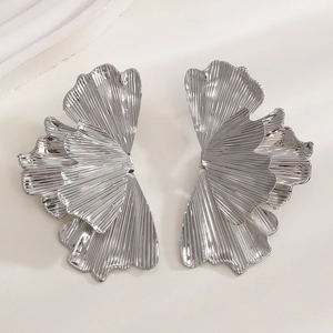 Macro detail of silver ginkgo leaf earrings with radial pleated metal texture