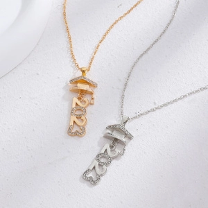 Macro shot of graduation necklace detail with 2023 cap pendant and sparkling cubic zirconia