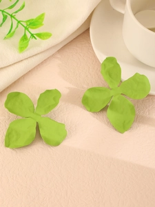 Detailed view of matte green flower stud earrings with realistic petal texture
