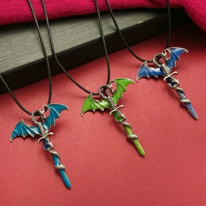 Retro dragon and sword pendant necklaces with colorful enamel on textured red background
