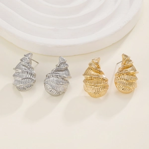 Minimalist spiral shell stud earrings in gold and silver finish with metallic texture