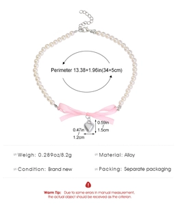 Detail view of pearl necklace with pink bow pendant showing alloy material and size specs