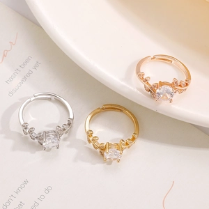 Close-up of adjustable laurel leaf rings in silver, gold, and rose gold with zircon