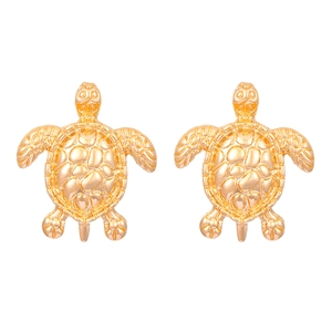 Detailed close-up of golden turtle stud earrings with honeycombed textured shell