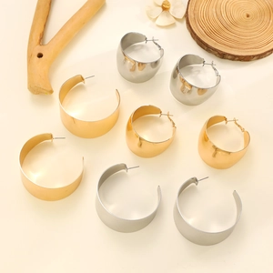 Polierte goldene und silberne C-förmige Creolen in minimalistischem hohlem Design