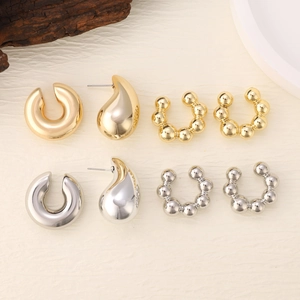 Polished gold and silver earring set featuring oval hollow hoops and droplet studs