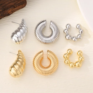 Detailed set of gold and silver minimalist textured hoop earrings and ear cuffs