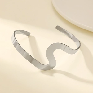 Close-up of polished silver wavy double-layer bangle with elegant metallic luster