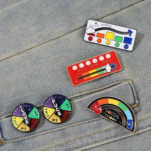 Interactive enamel mood pins with sliding social battery bars on denim fabric background